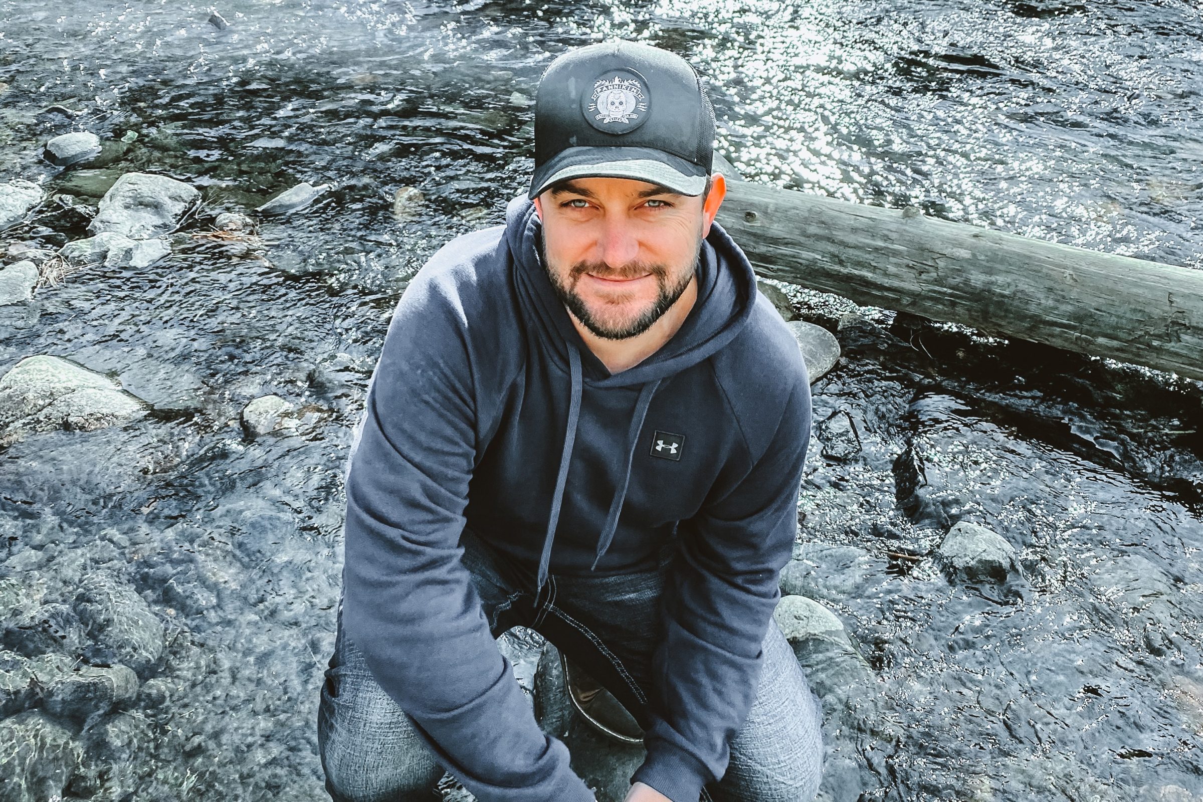 Joshua Brown crouched beside a rocky mountain river near Denver.